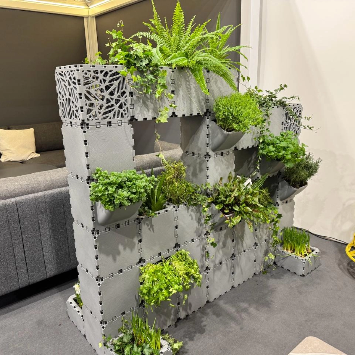 Grey Cubik modular green wall planter at an exhibition stand
